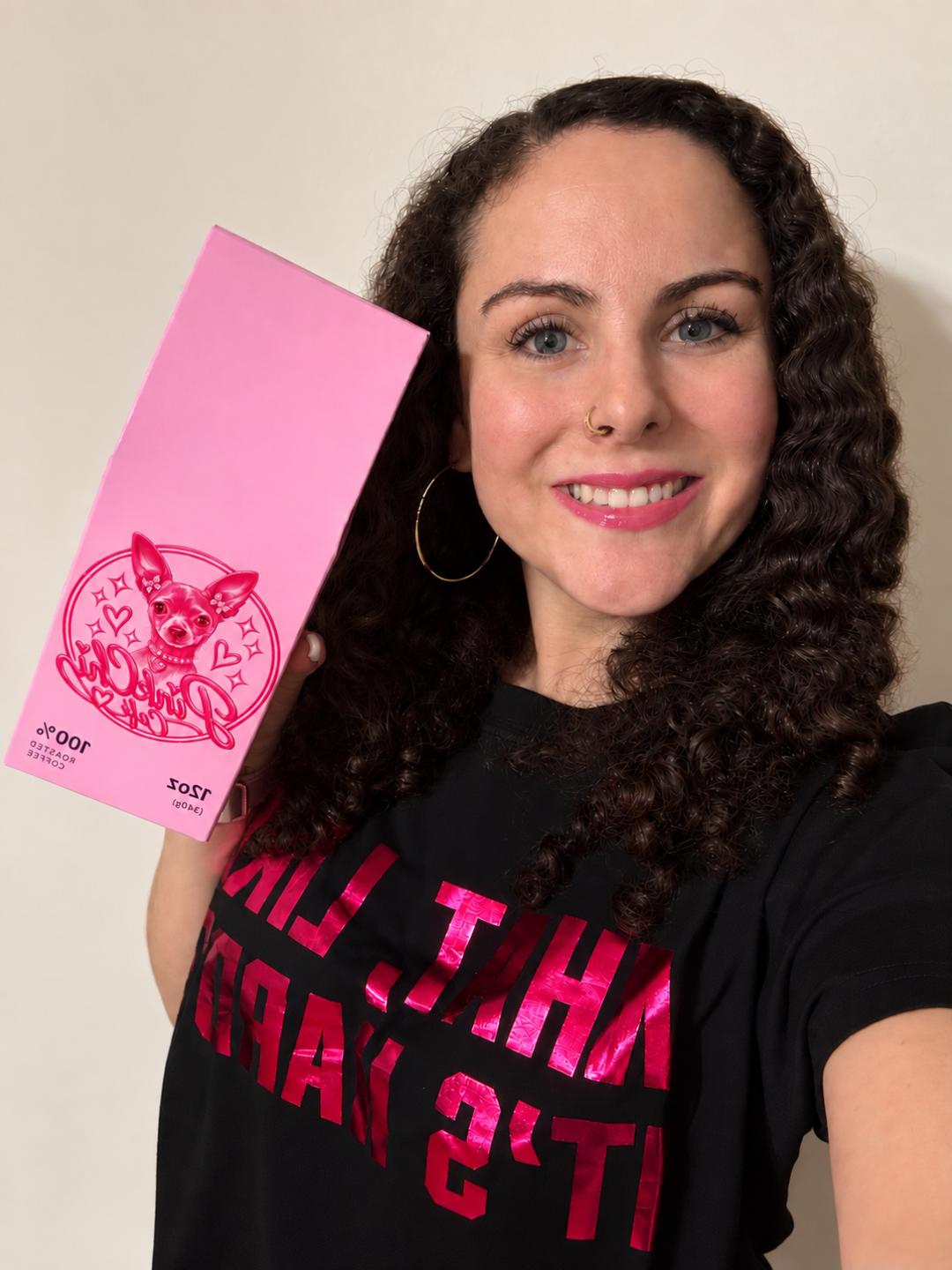 Pink Chi Café founder holding a Pink Chi House Blend coffee box